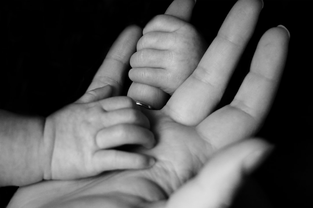 Photo by Liv Bruce photo of baby holding person's fingers